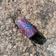Colorful marbled object on a textured stone surface