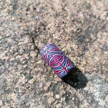 Colorful patterned object on a textured stone surface